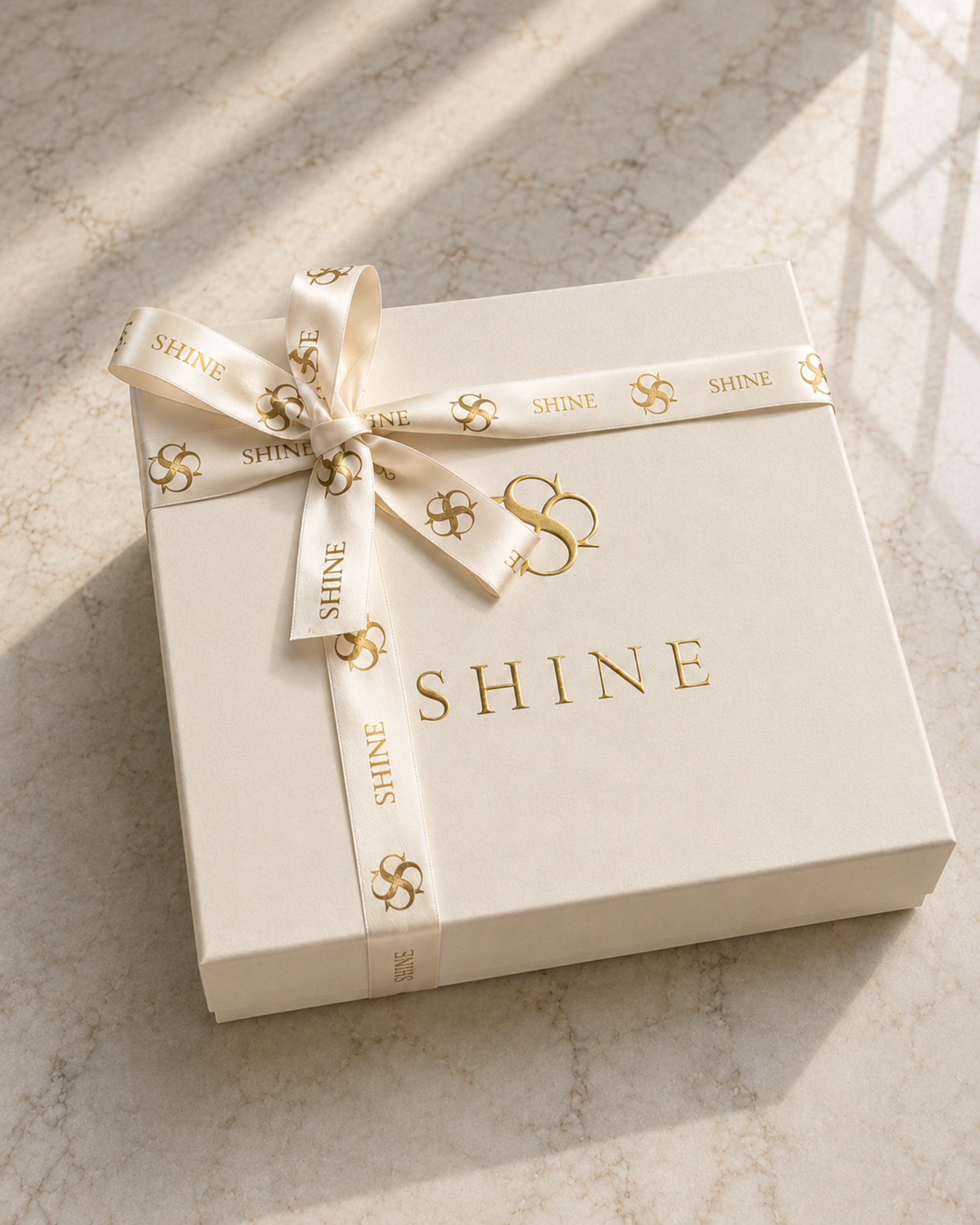 House of Shine signature gift box for the Bijou in Bare Silk, cream box with gold foil branding, satin lining and branded ribbon, luxury handcrafted packaging, Bijou Edit.
