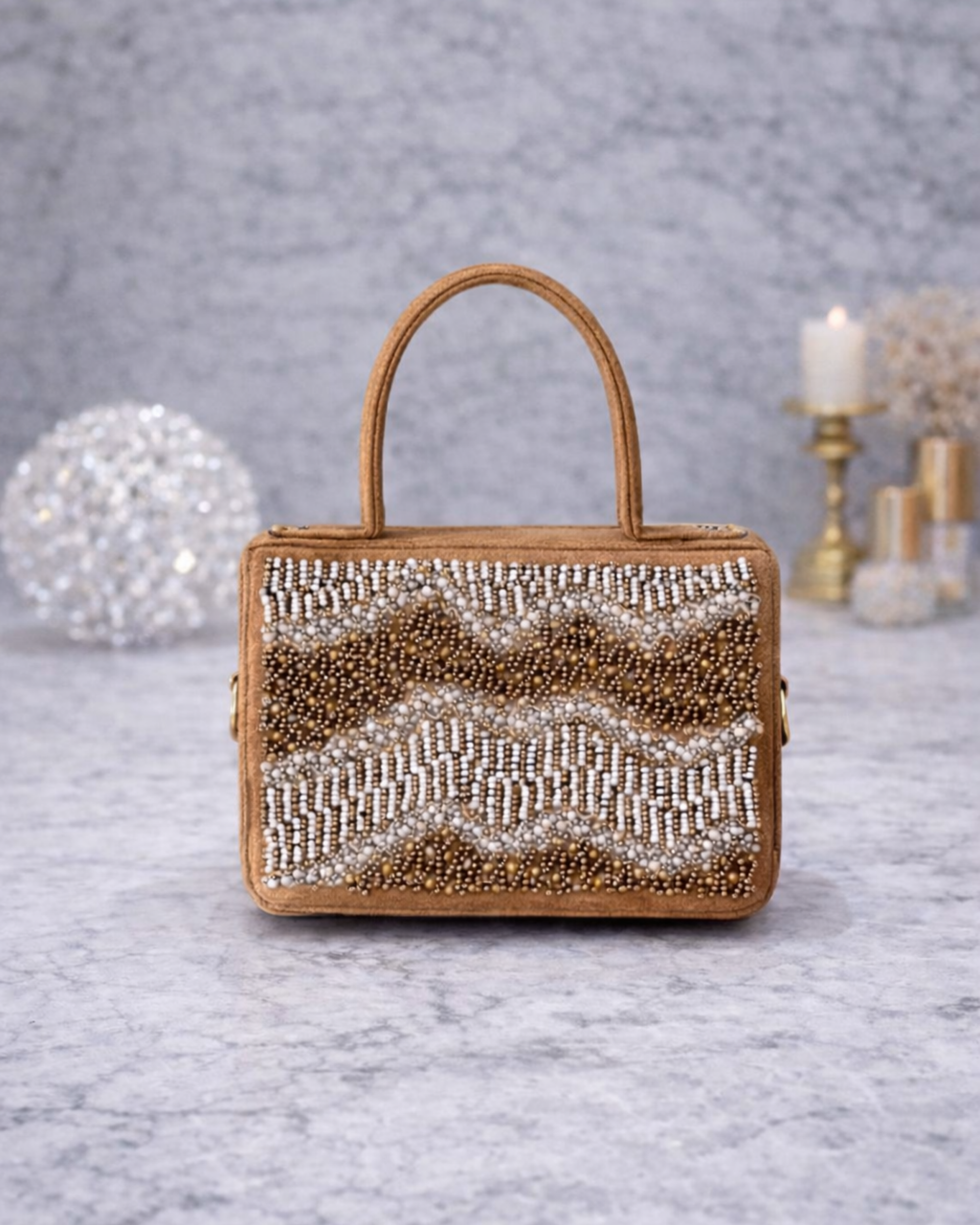 Boho hand-beaded caramel butter suede satchel by House of Shine front view with rose gold and silver beading on marble surface.