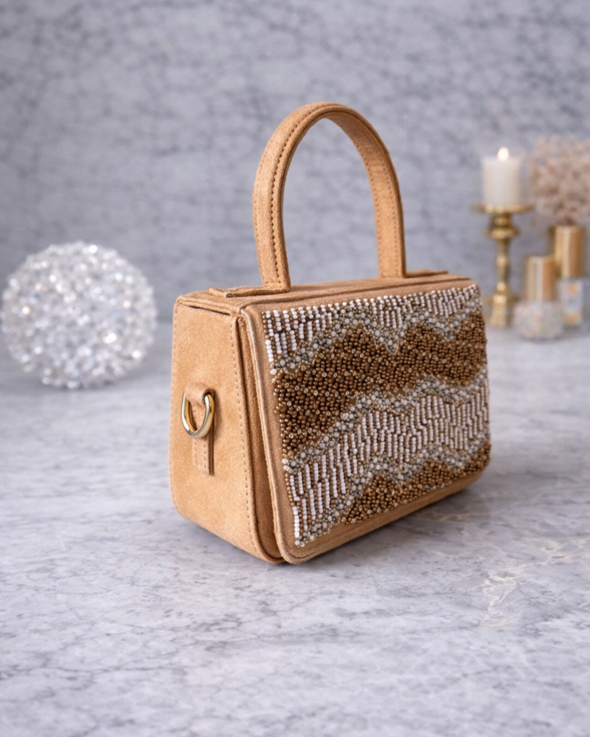Boho caramel butter suede satchel by House of Shine side angle showing hand beading and gold hardware on marble.