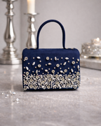 Estrella hand-embellished midnight navy satchel by House of Shine front view cascading rhinestone constellation pattern on marble with scattered crystals