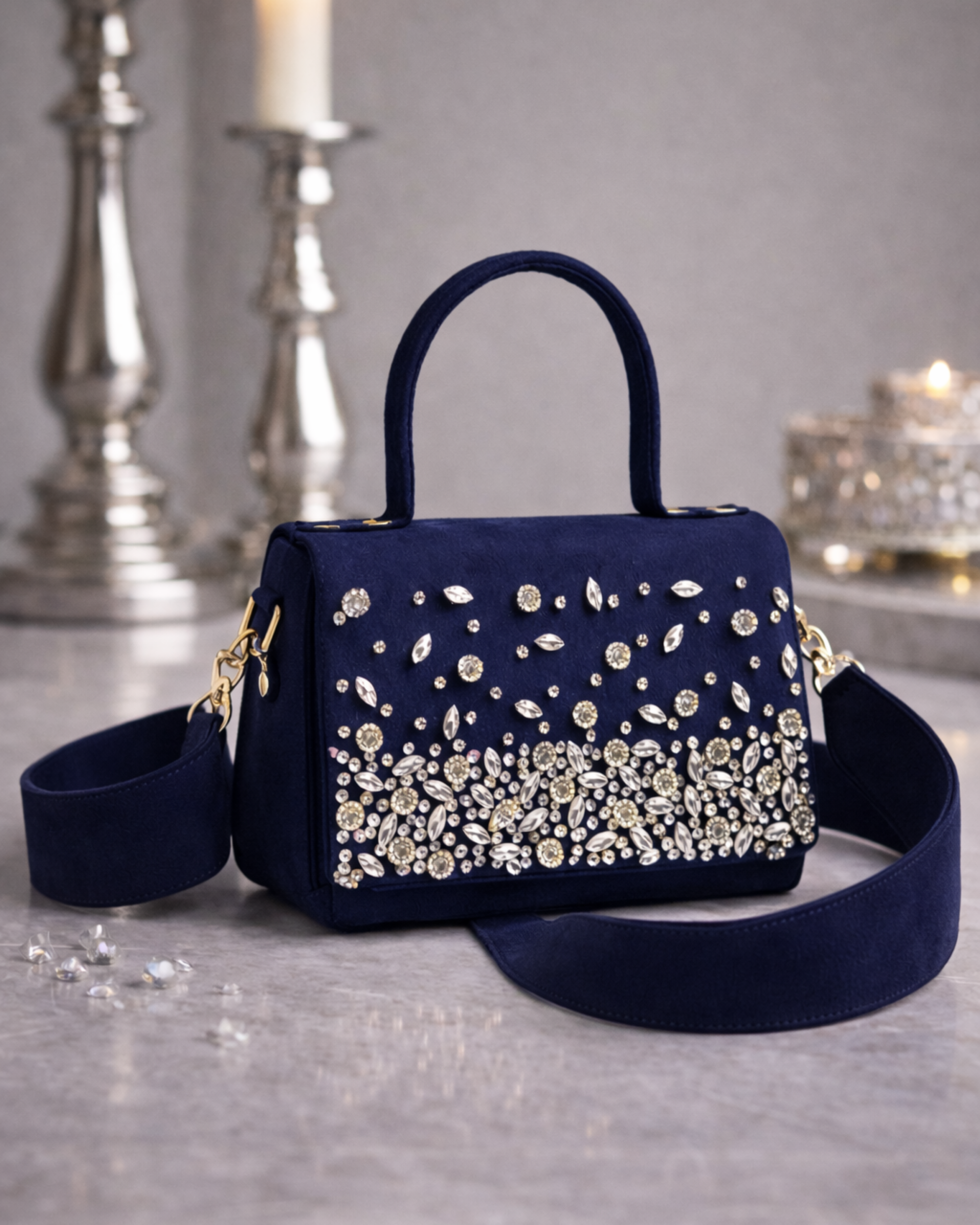 Estrella hand-embellished midnight navy satchel by House of Shine front view with cascading rhinestones and wide suede crossbody strap on marble surface