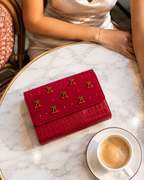 Overhead flatlay of The Amarena hand embroidered bag on a marble café table with coffee
