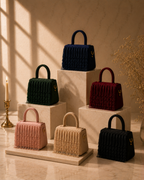 All six Cascade Satchel colorways displayed together on marble pedestals