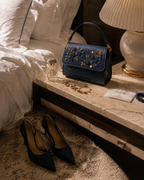 Mirtillo crafted by Indian artisans styled on a bedside table with perfume, gold jewellery, and heels