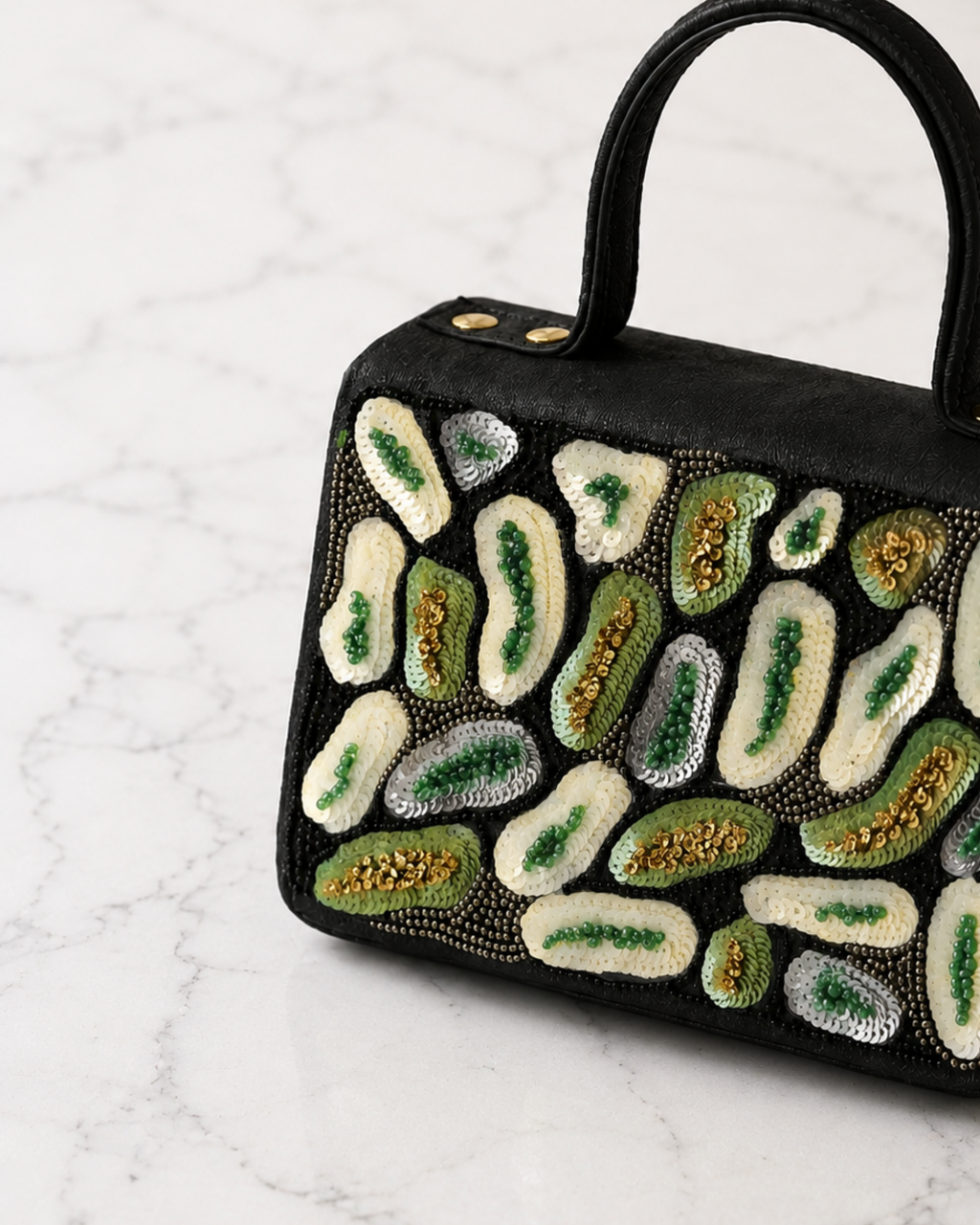 Close-up detail of The House of Shine Prisma satchel showing intricate hand embroidery with ivory, green and gold sequins and beads on black fabric