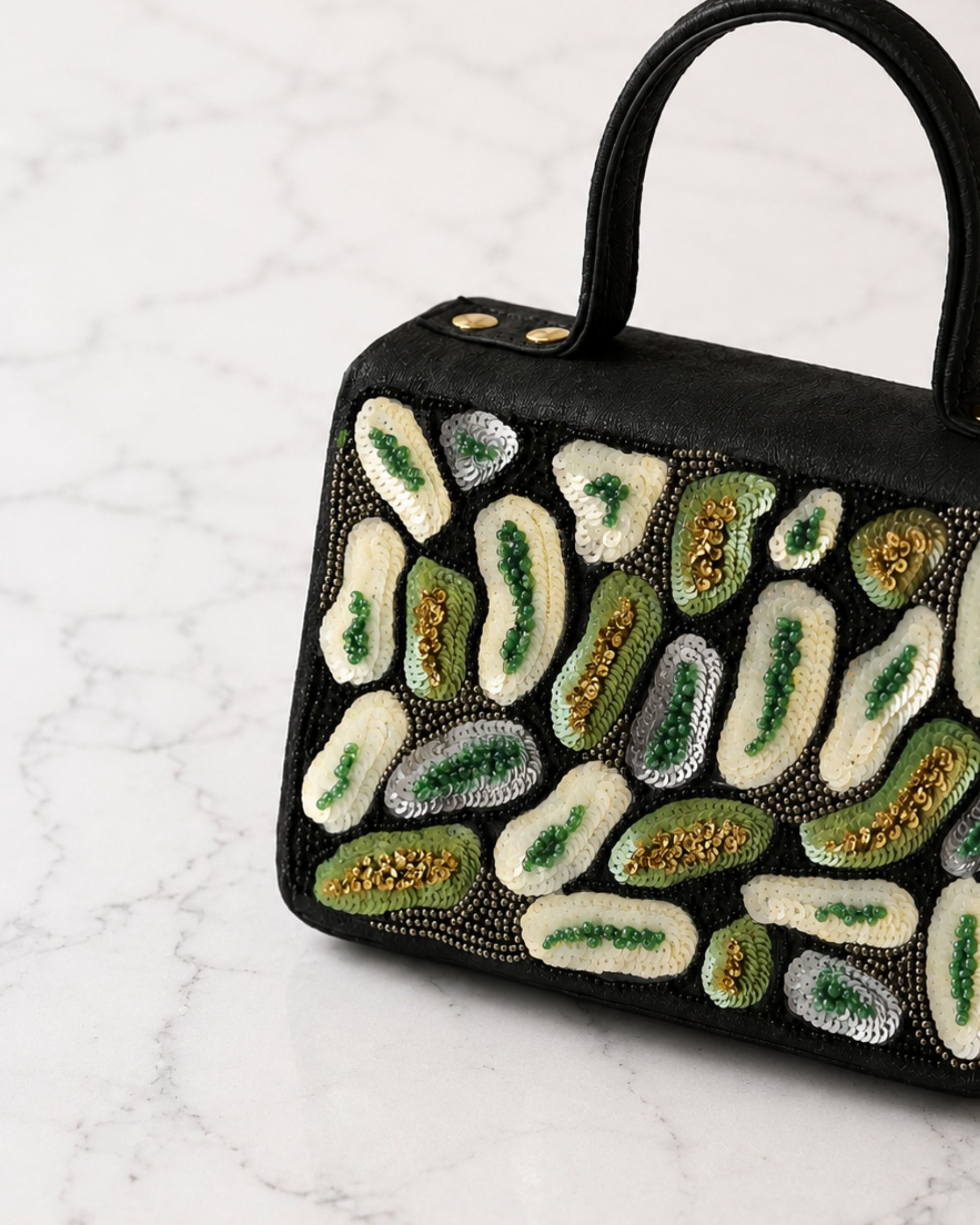 Close-up detail of The House of Shine Prisma satchel showing intricate hand embroidery with ivory, green and gold sequins and beads on black fabric