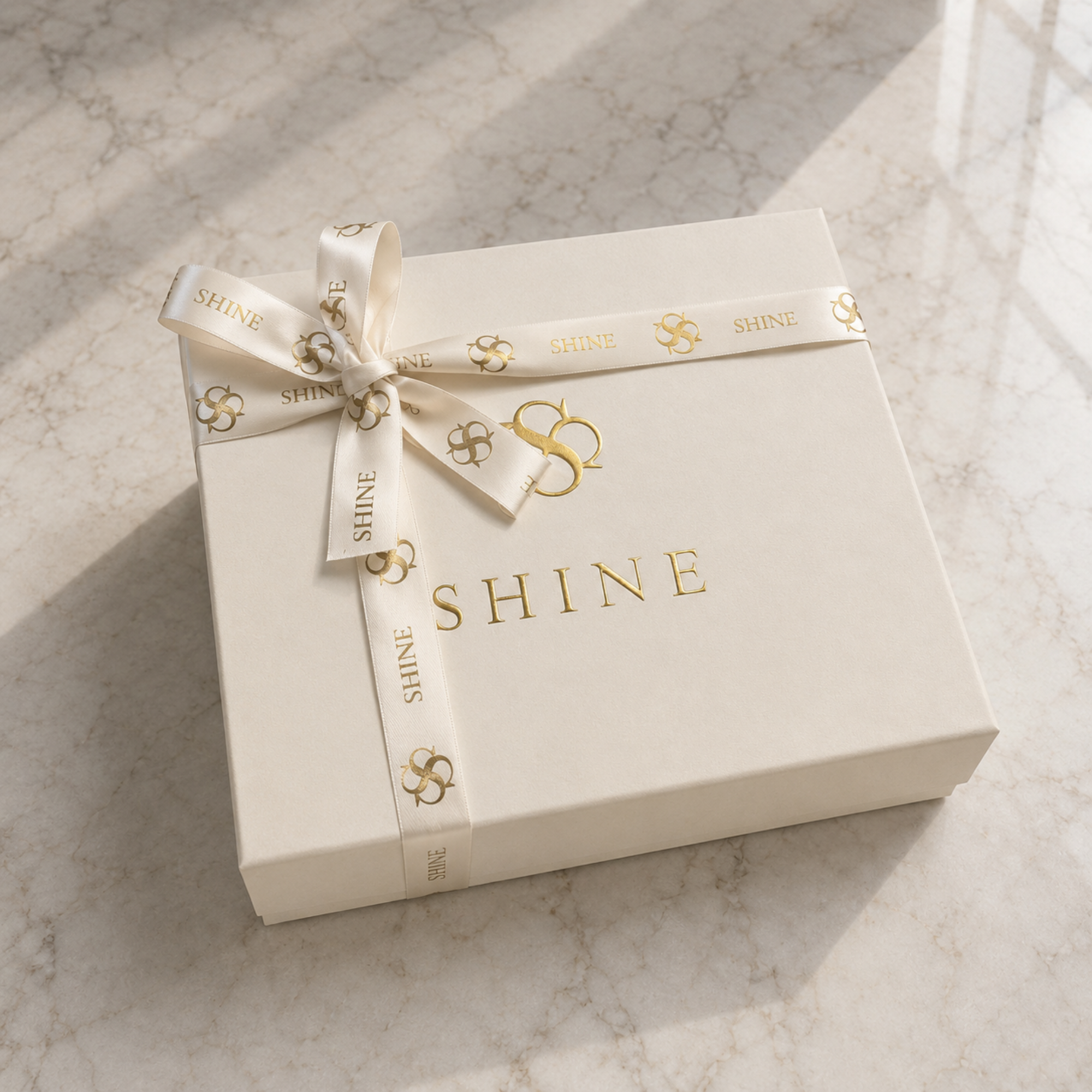 House of Shine signature gift box for the Bijou in Moonlit, cream box with gold foil branding, satin lining and branded ribbon, luxury handcrafted packaging, Bijou Edit.