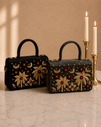 House of Shine Tropical Moonbeam Satchel in black and charcoal velvet displayed side by side, hand embroidered luxury handbag India with gold palm tree motif