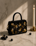 Nocturne Satchel in black with dark grapes and lit candle on marble, Noir Atelier by The House of Shine
