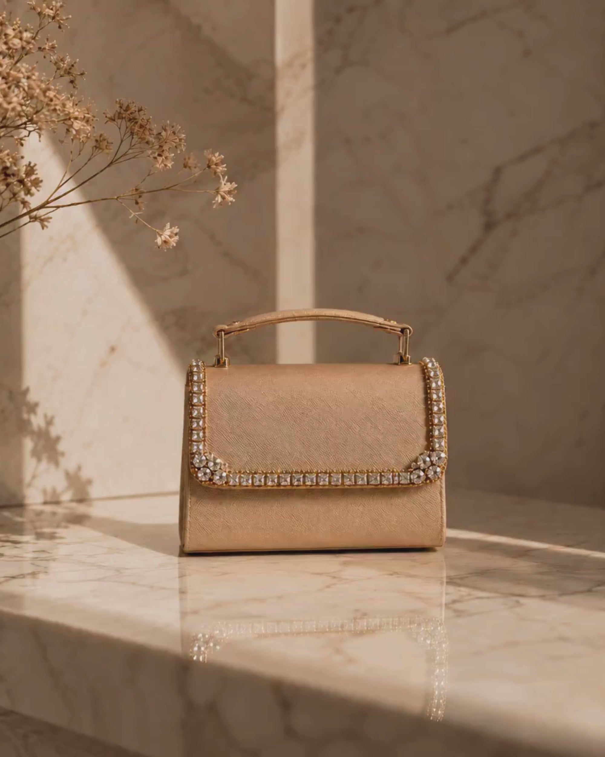 Close-up video of Liquid Gold crystal-embellished mini bag by House of Shine, camera zooming in and out to show hand-set crystal trim, saffiano texture, and gold-polished hardware, Bijou Edit.