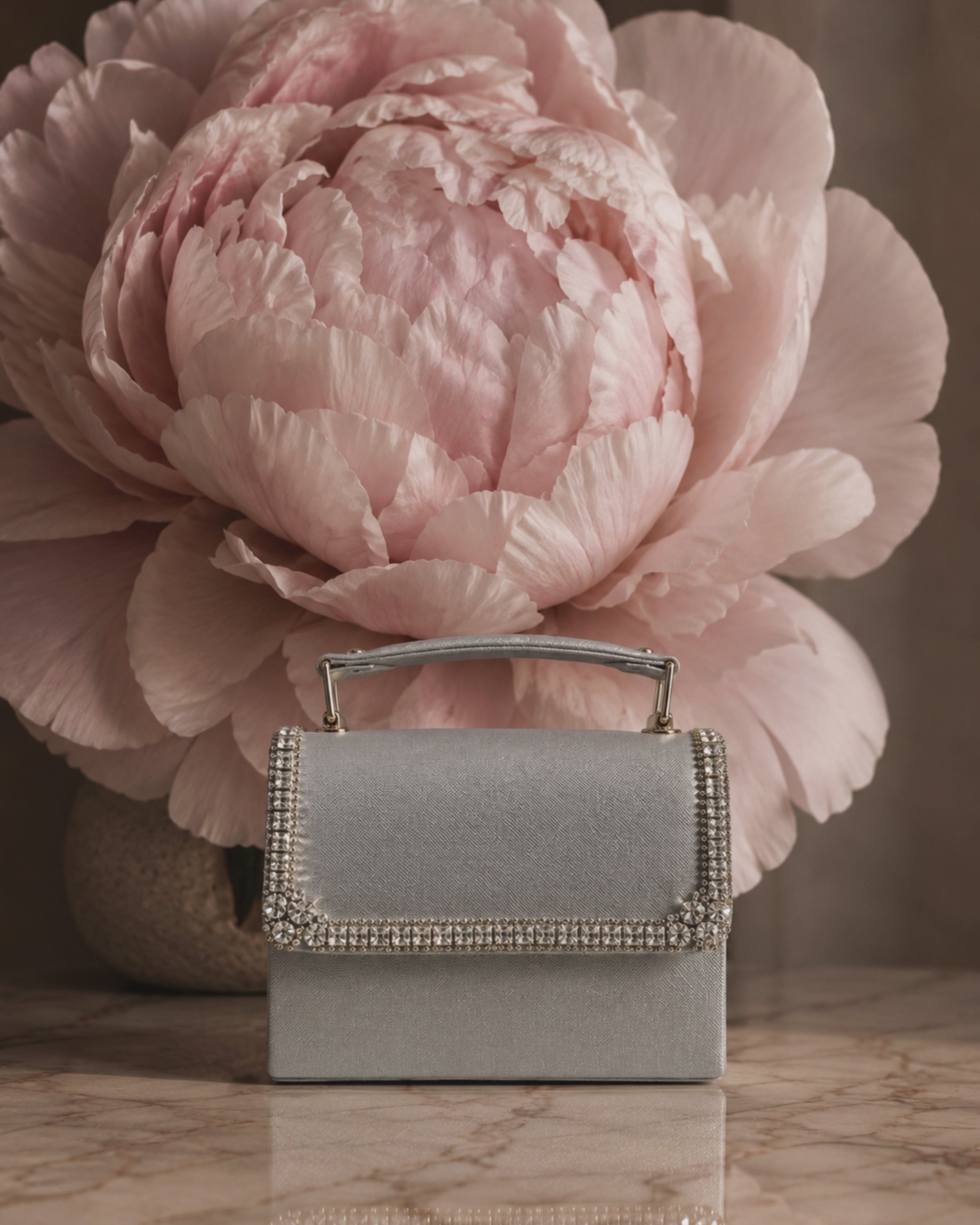 Close-up video of silver Moonlit crystal-embellished mini bag by House of Shine, camera zooming in and out to show hand-set crystal trim, saffiano texture, and gold-polished hardware, Bijou Edit.