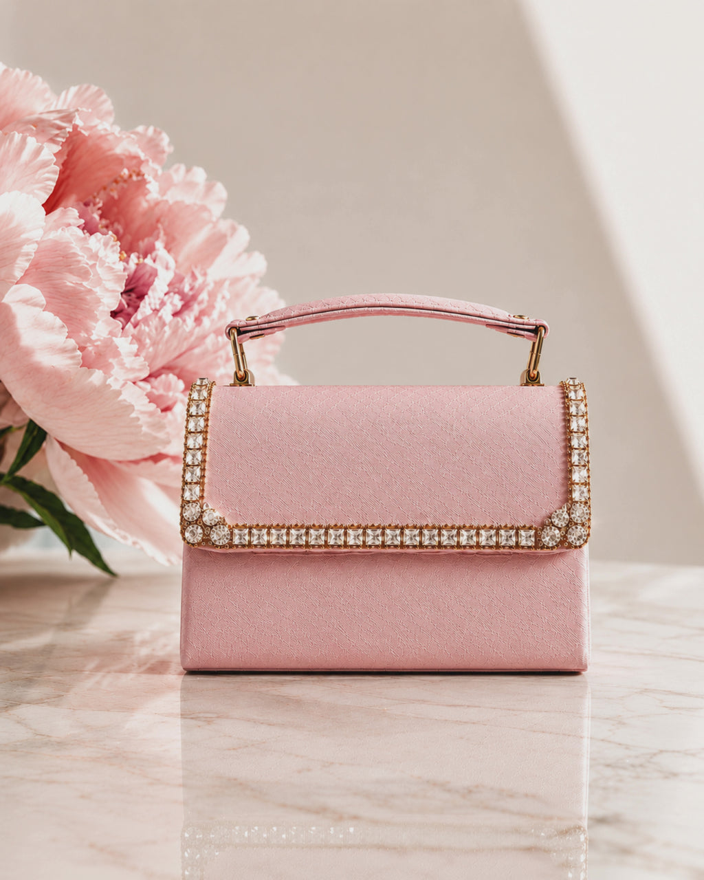 Close-up detail video of blush pink crystal-trimmed mini bag, zooming into the hand-embellished flap with square and round cut crystals in antique gold setting, The House of Shine Bijou Edit