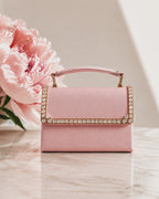 Close-up detail video of blush pink crystal-trimmed mini bag, zooming into the hand-embellished flap with square and round cut crystals in antique gold setting, The House of Shine Bijou Edit