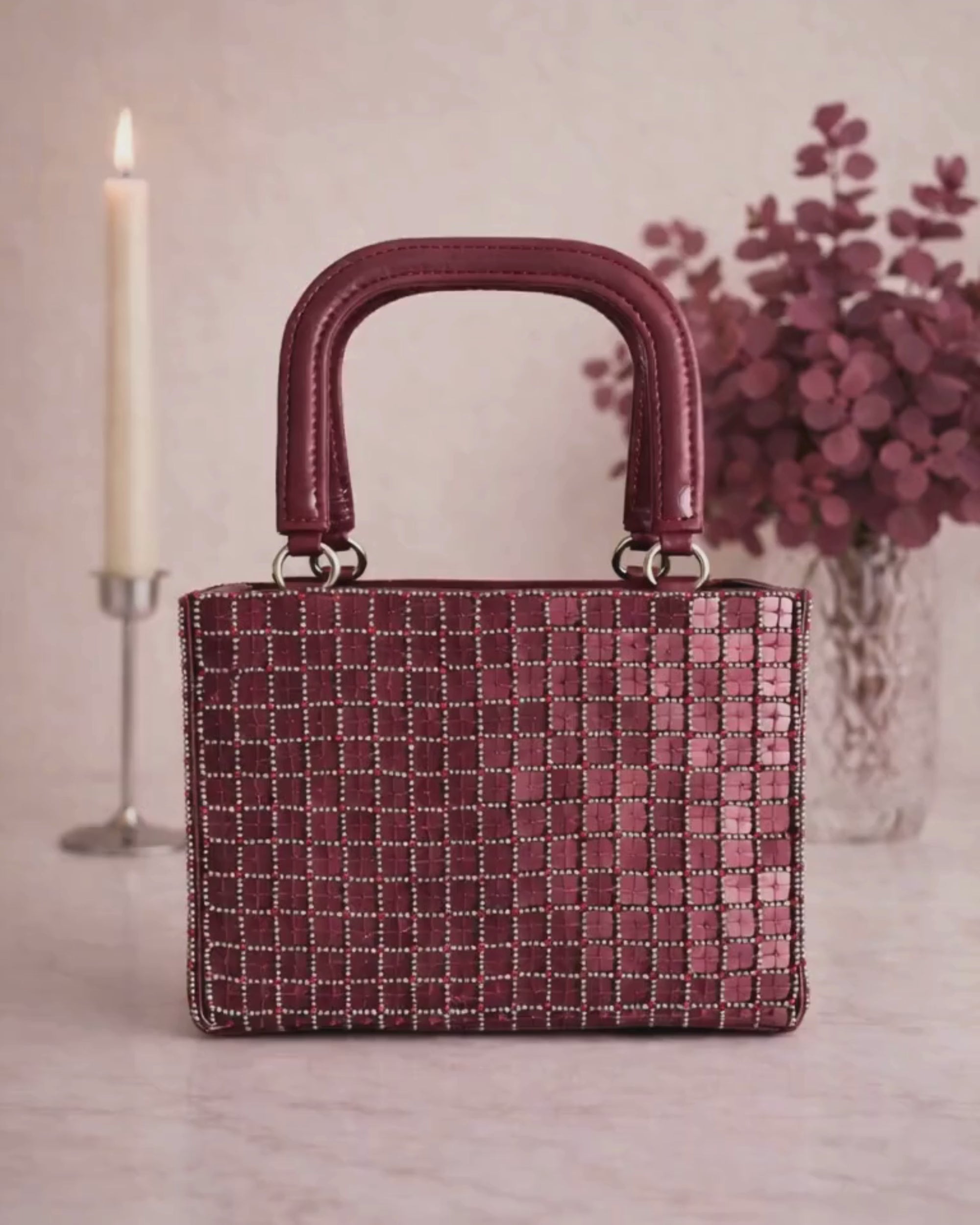 Zoom in and out video of hand-set cut dana beadwork on Valentina Mini Tote in burgundy, Noir Atelier by The House of Shine