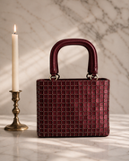 Valentina Mini Tote in burgundy cut dana embroidery with brass candlestick on marble, Noir Atelier by The House of Shine